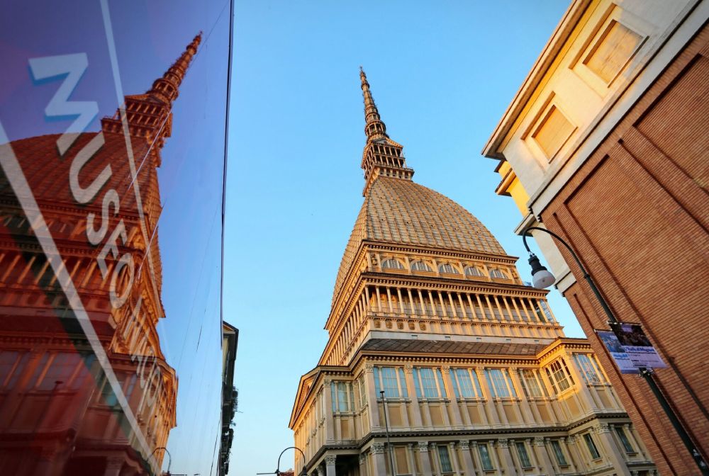 Reflection of the Mole Antonelliana in a glass façade, Turin, Italy