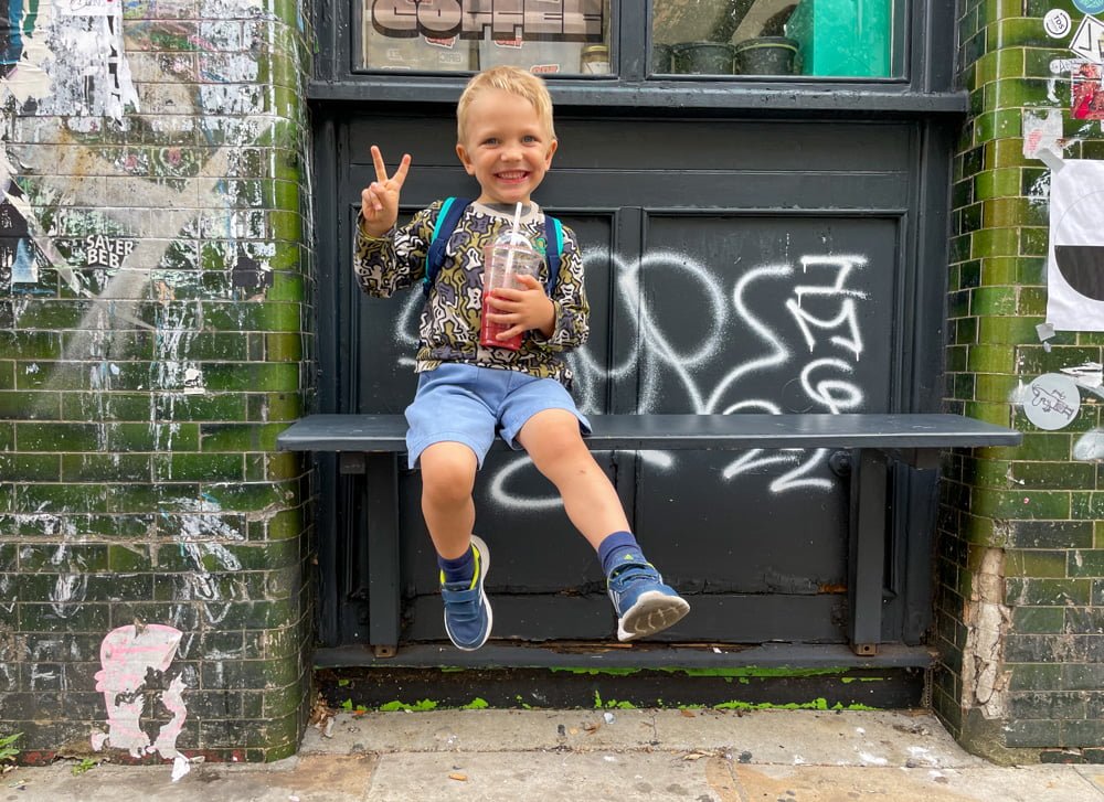 Ben Bertoni enjoying a fresh fruit juice among the street art in Brick Lane, London