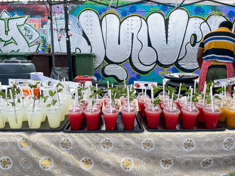 Fresh fruit juices at a street food stall in Brick Lane Market