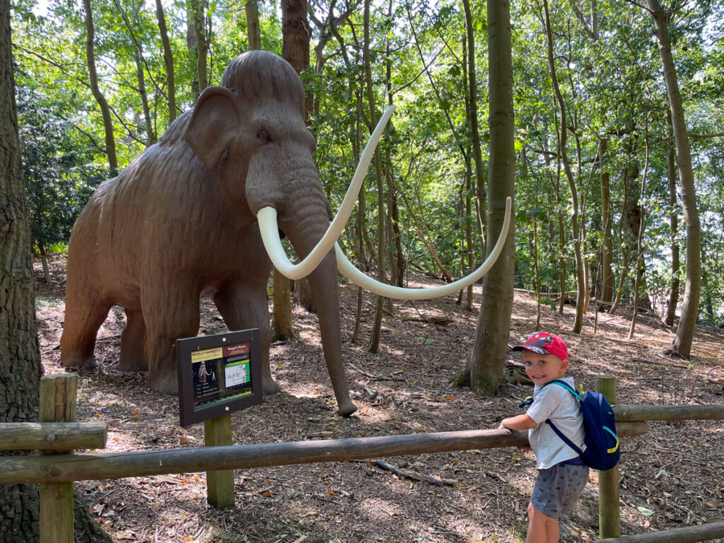 Ben Bertoni in front of a mammoth at Roarr! dinosaurs park in Norfolk