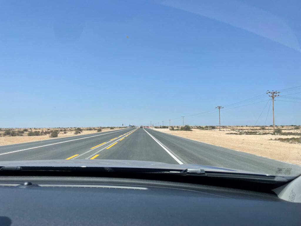 A street in Northern Qatar surrounded by desert