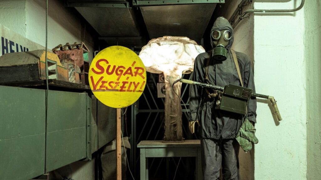 Radiation hazard "sugár veszély" sign and gas mask in the Hospital in the Rock Nuclear Bunker Museum in Budapest
