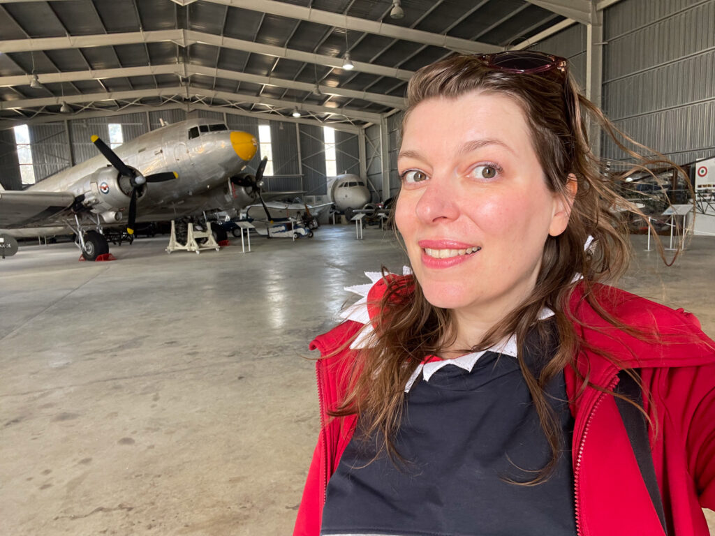 Paola Bertoni in front of a Douglas Dakota at the Malta Aviation Museum