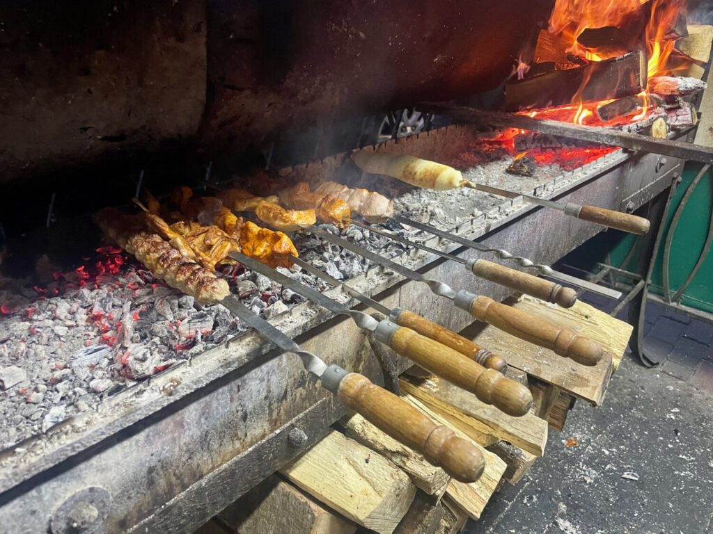Grilled meat skewers cooked outside Tavaduri restaurant in Batumi, Georgia