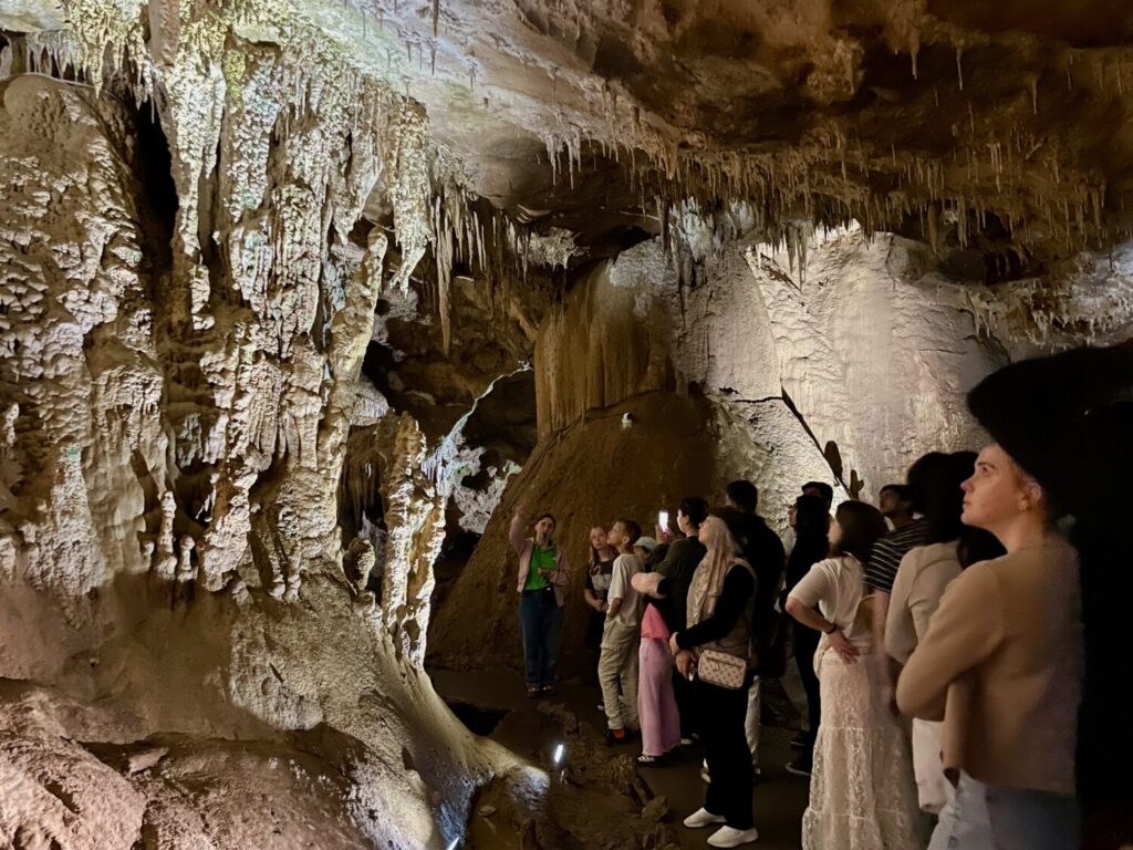 Tourists exploring the Prometheus Cave in Georgia