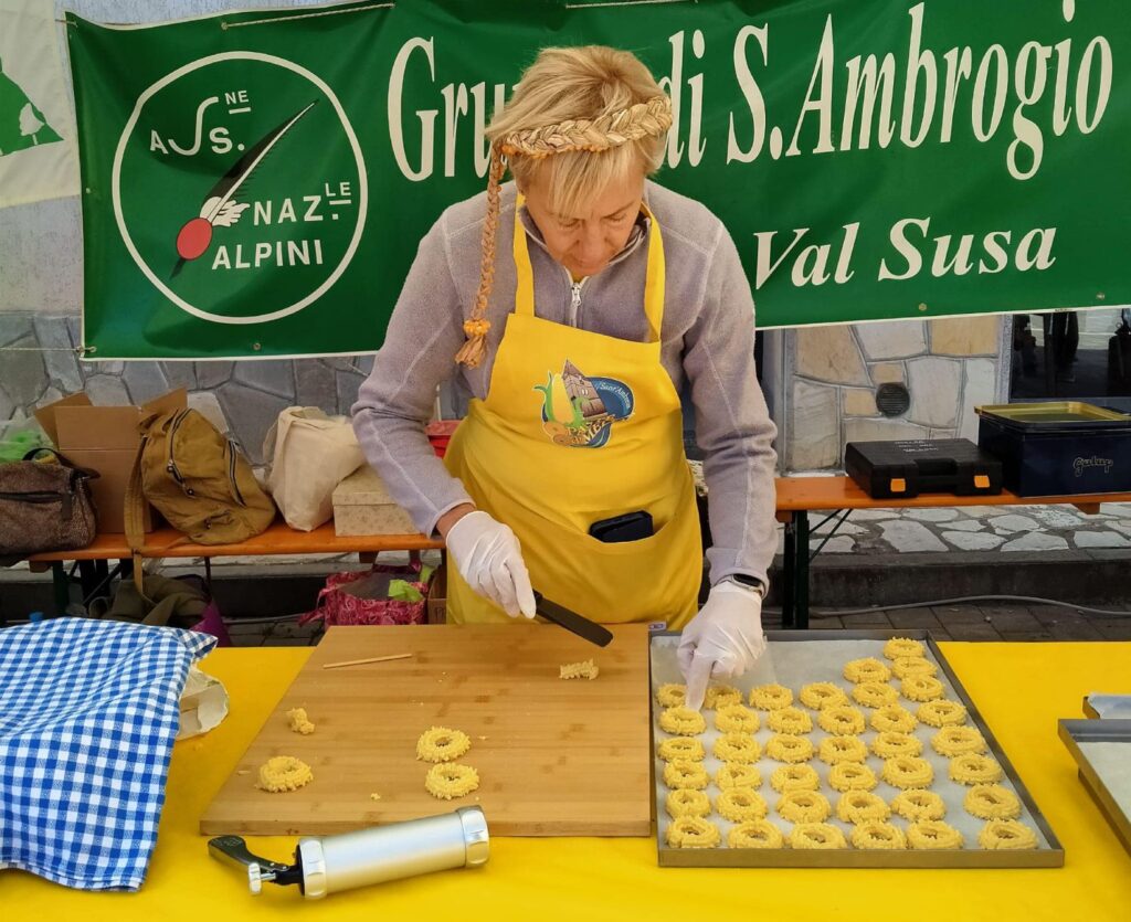 A demonstration of cornmeal pastry making during Meliga Day in Sant'Ambrogio di Torino.