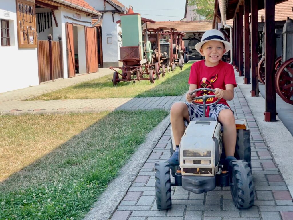 My son on a toy tractor at the Agricultural Machinery Museum in Mezőkövesd, Hungary