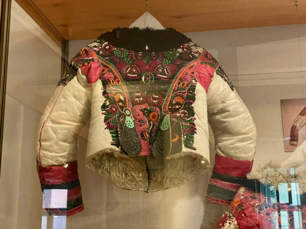 A richly decorated sheepskin jacket featuring colourful Matyó motifs at the Matyó Museum in Mezőkövesd