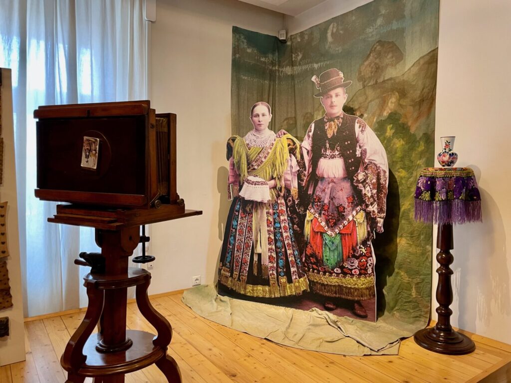 A reproducion of a 19th-century photo studio with locals dressed in Matyó costumes at the Matyó Museum in Mezőkövesd