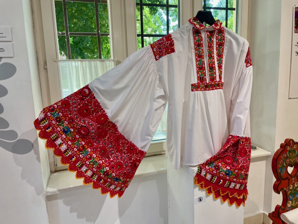 A men’s shirt with bright red floral embroidery typical of Matyó style at the Matyó Museum in Mezőkövesd, Hungary