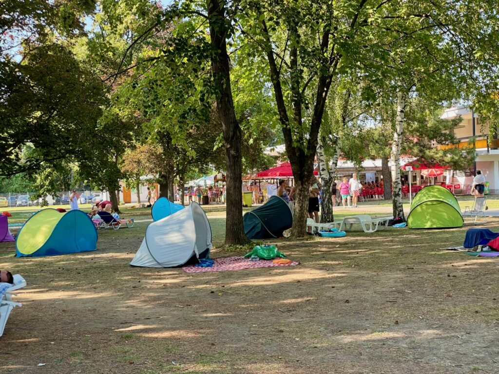 Hungarian families' sunshade tents in the Zsóry Fürdő's park in Mezőkövesd