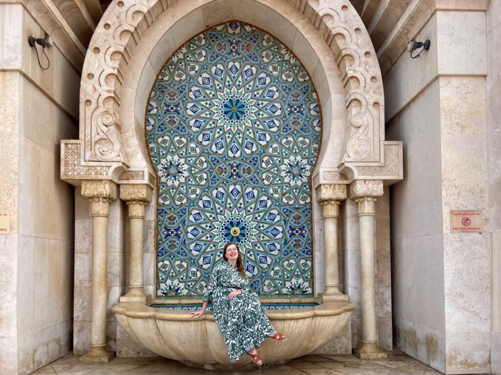 Paola Bertoni in front of a fountain on the esplanade of the Hassan II Mosque in Casablanca