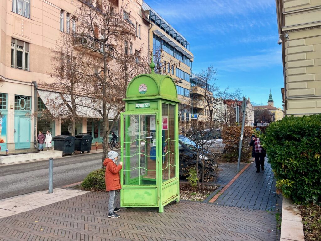 Ben Bertoni next to an old phone booth in Szeged