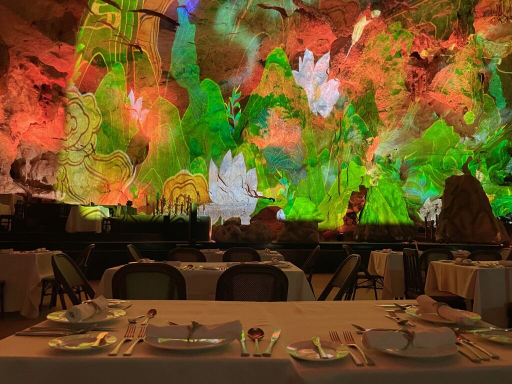 Light show inside Dragon Pearl Cave in Ha Long, Vietnam