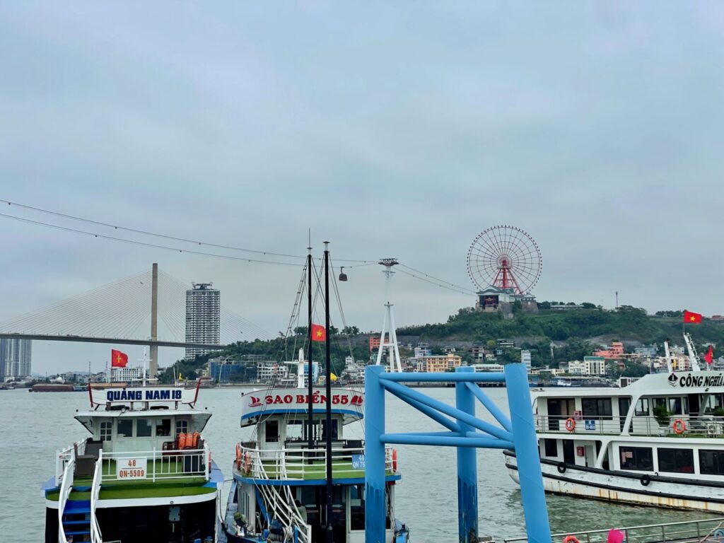 Ha Long Bay harbour, with cable car, skyscrapers, Ferris wheel and theme park in the background