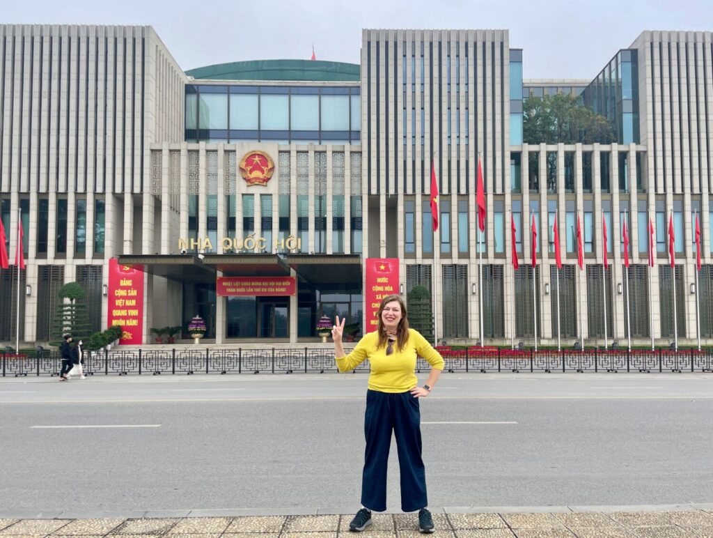 Paola Bertoni in front of a government building in Hanoi, Vietnam