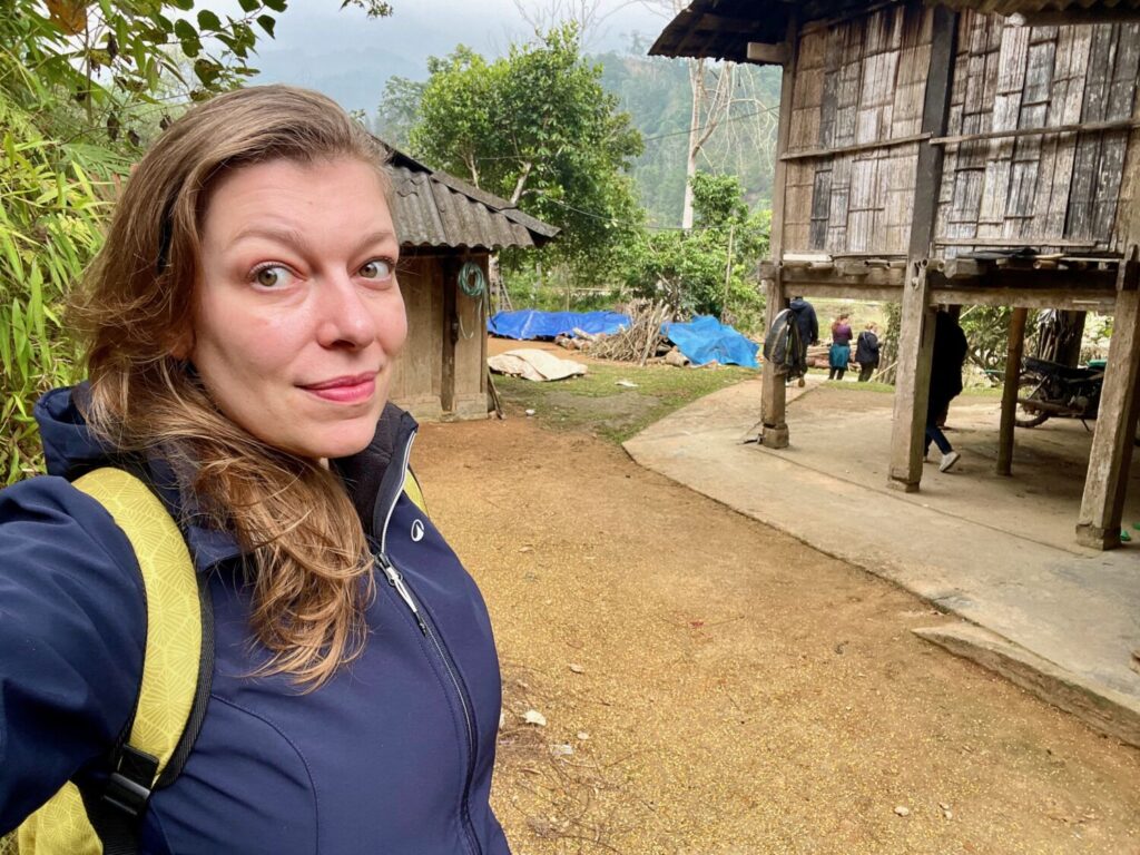 Paola Bertoni in front of a traditional Tay house in Hoang Su Phi, Vietnam