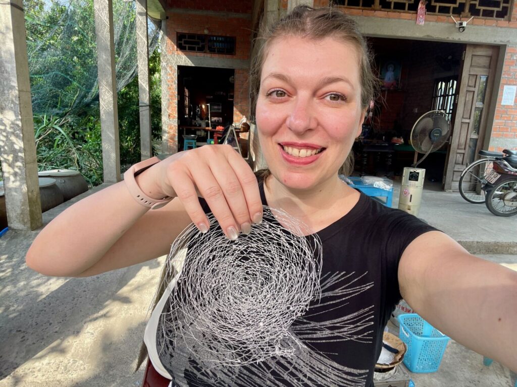 Paola Bertoni holding a sheet of rice paper I made in Tan Phong, in the Mekong Delta, Vietnam