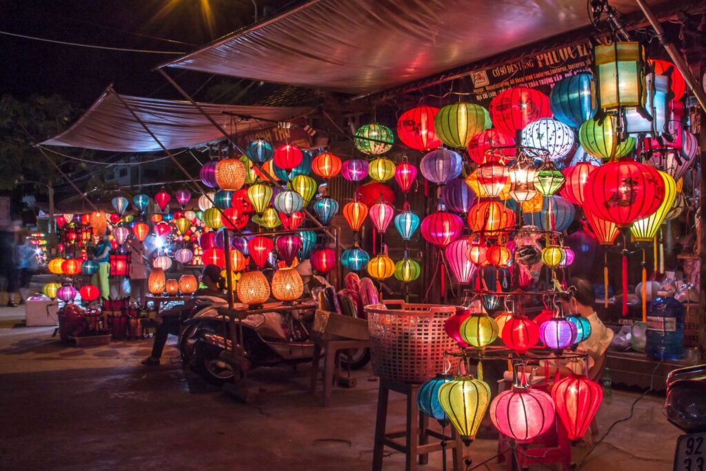 Souvenir shops in the evening with illuminated lanterns in Hoi An, Vietnam