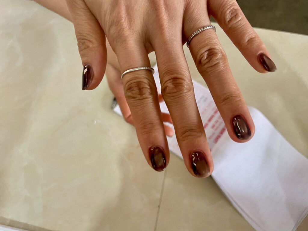 Impeccable cat eye semi-permanent manicure worn by a waitress in a remote roadside café in the mountains of Hoang Su Phi, Vietnam