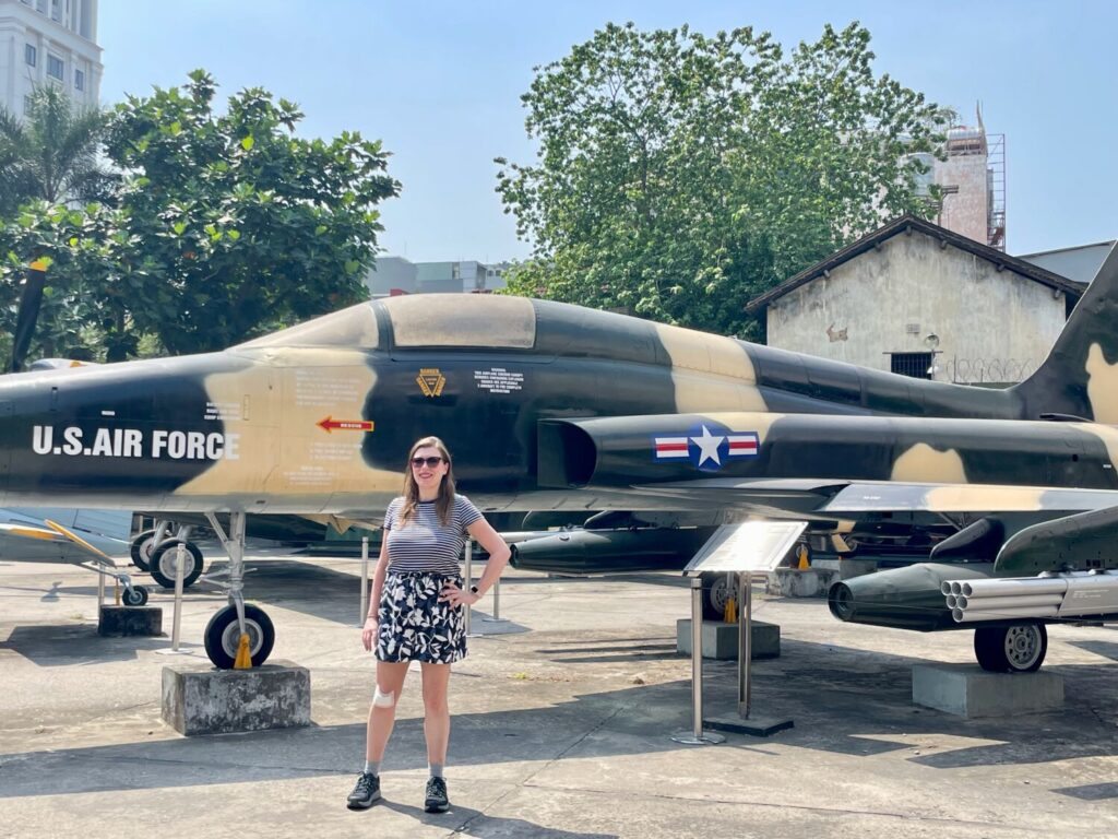 Paola Bertoni in the outdoor area with a military aircraft at the War Remnants Museum