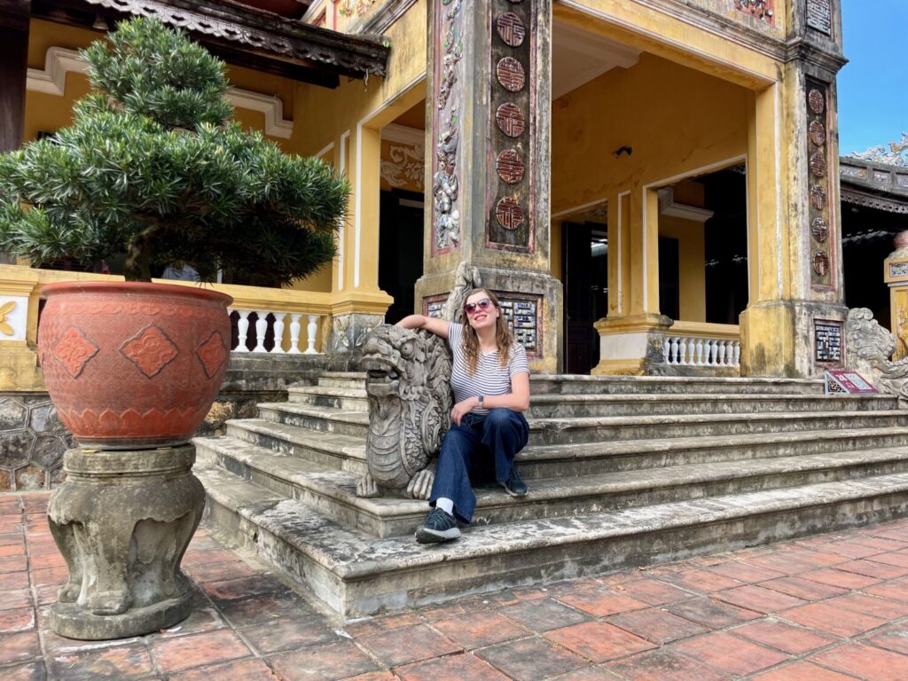 Paola Bertoni in front of the Queen Mother’s Palace in the Forbidden Purple City of Hue