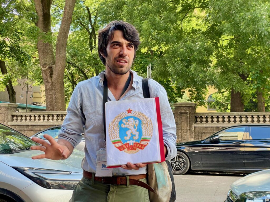 Dino, my guide on the Communist Tour in Sofia, with the coat of arms of Communist Bulgaria