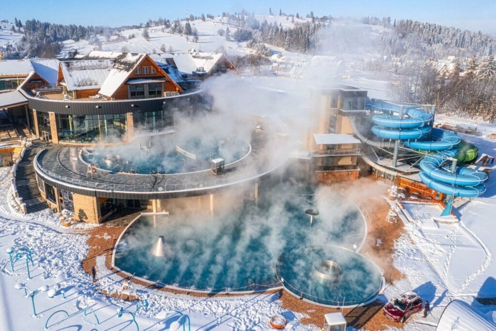 The Chochołów Thermal Baths in Poland in winter, surrounded by snow-covered mountains
