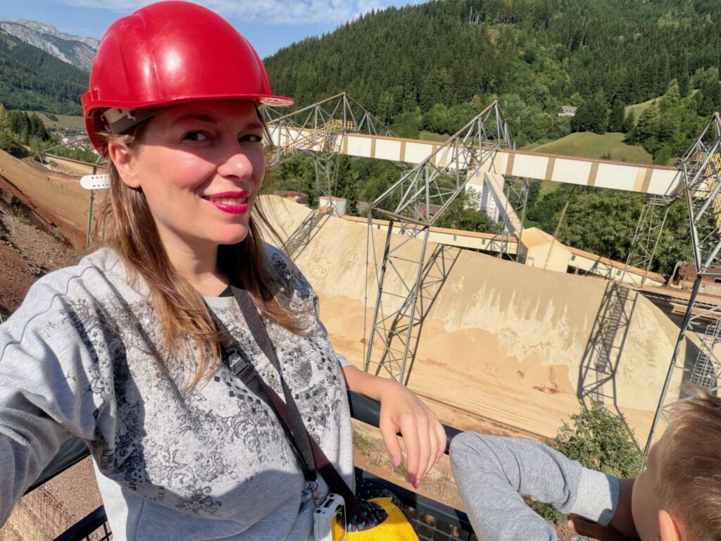 Paola Bertoni with a red helmet on the Hauly's viewing platform at Erzberg Mine
